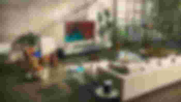 LG G3 TV sat in a well-lit room next to a window sat in front of a cream sofa and glass table.