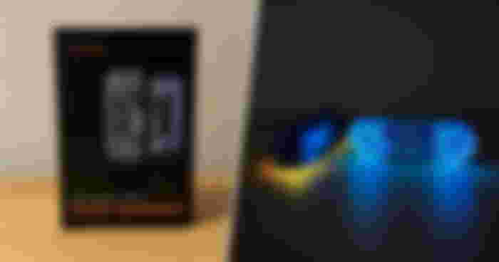 On the left, a black box featuring an image of two blue hand warmers. On the right, an image of them while on and showcasing their yellow and blue lighting.