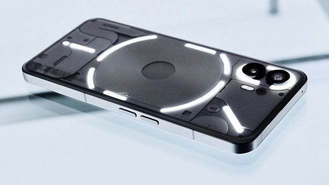 Nothing Phone (2) with the glyph lit up on a glass counter