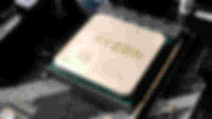 Close-up of a gold, white, and green CPU inside a laptop.