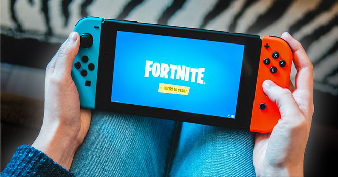A Nintendo Switch Lite displaying Super Mario Odyssey.