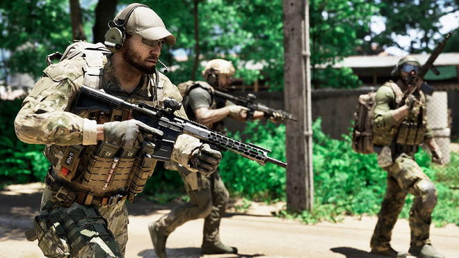 Three soldiers in full camo gear walking down a road, each one carrying a rifle.