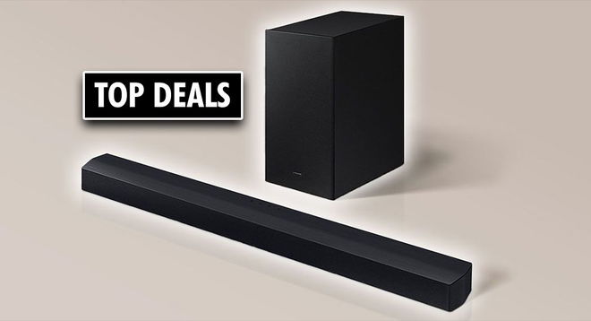 A black rectangular soundbar next to a subwoofer in front of a biege background. Alongside, a black and white "TOP DEALS" label.