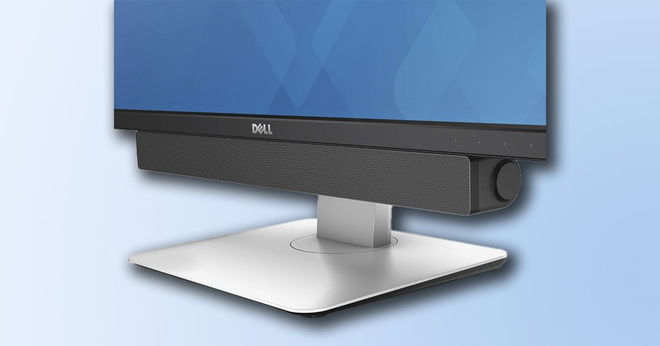 A silver and black Dell monitor with a long black soundbar connected to the underside of it.