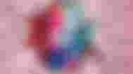 TikTok Logo on an iPhone screen in front of a breaking wall