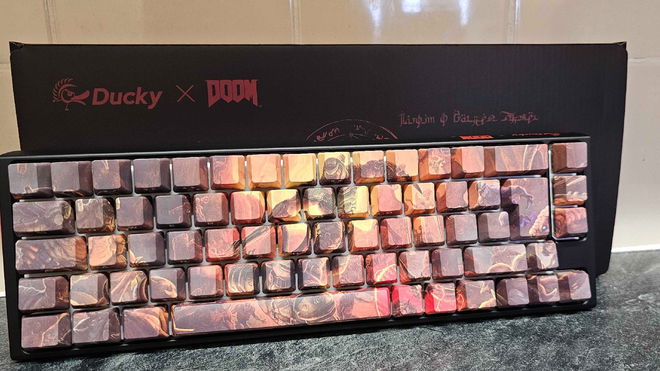 Ducky x DOOM One 3 SF keyboard lying at an angle against the box