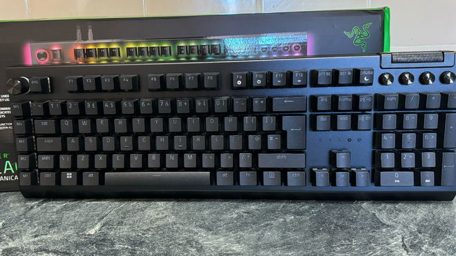 Razer BlackWidow V4 Pro in front of its box and on a marble countertop