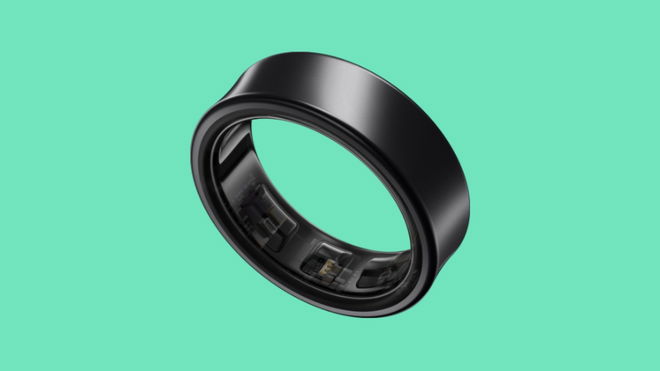 A black Samsung Galaxy Ring at a slight angle placed against a turquoise background.