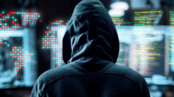 A hooded man looking at various augmented screens as an interpretation of hacking