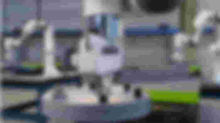 PhysX based simulation of robots screwing nuts onto bolts, in Omniverse.