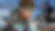 Solid Snake from Metal Gear Solid on top of an image of a military robot with a rifle on top.