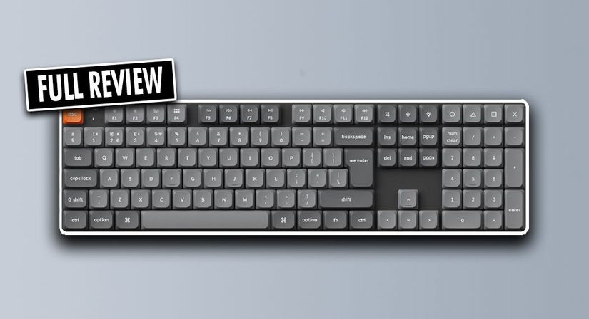 A black keyboard with two grey shade key caps and an orange ESC key. In the corner, a "FULL REVIEW" label in black and white.