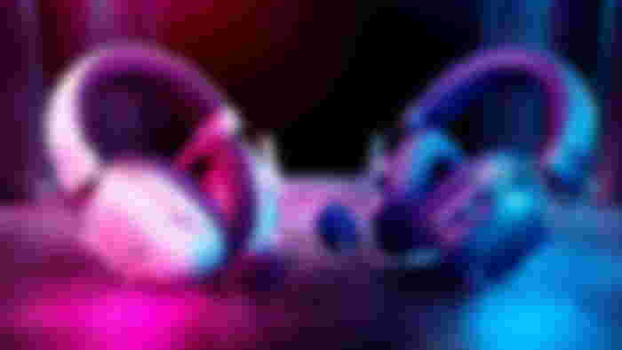 An image of a white and black pair of Razer BlackShark V2 Pro headsets on a red and blue background.