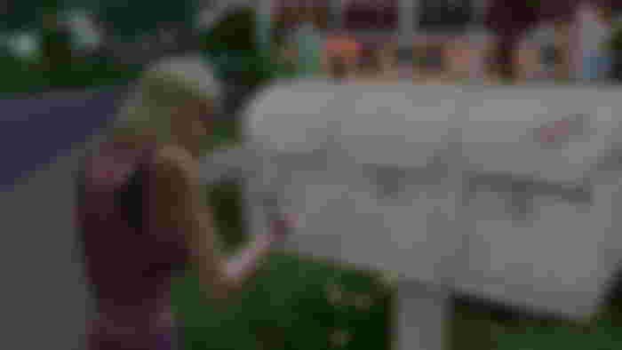 A Sims 4 character snooping through a mailbox