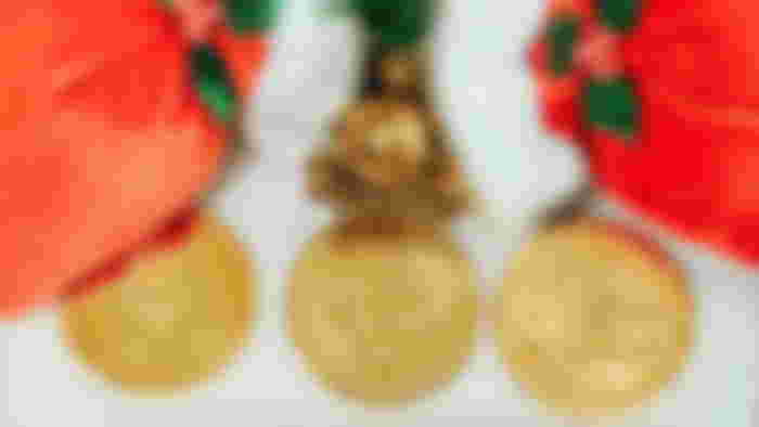 Ethereum coin, Bitcoin, and Litecoin under two Santa Claus hats