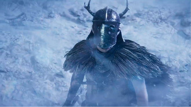 Character in armor from Behemoth trailer in an icy environment, looking up slightly towards the camera.