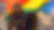 The Starfield protagonist sitting against an LGBTQ+ flag