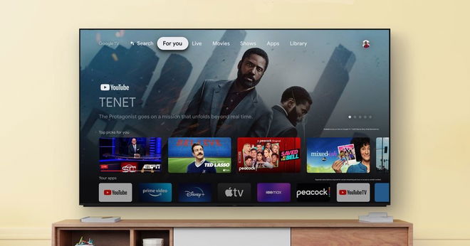 A flat screen TV mounted to a yellow wall with multiple apps and shows on the display.
