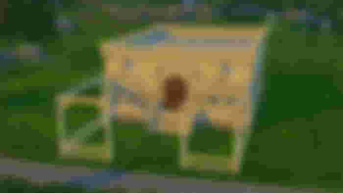 The Sims 4 Castle Estate kit creating a square castle in a grass field