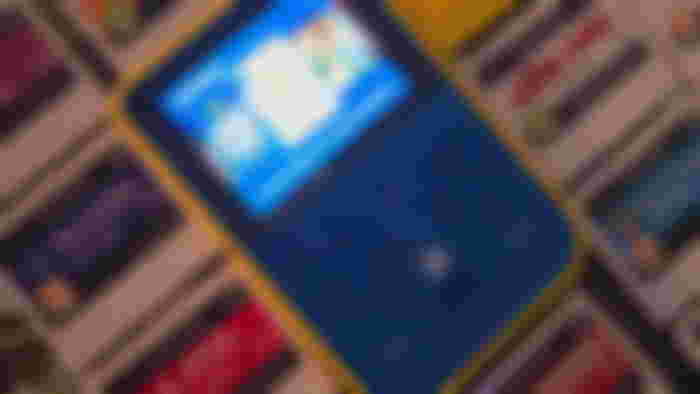 A HyperMegaTech Super Pocket Capcom Edition surrounded by Evercade cartridges
