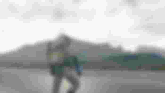 Screenshot of Sam Porter staring at a mountain in Death Stranding on iPhone