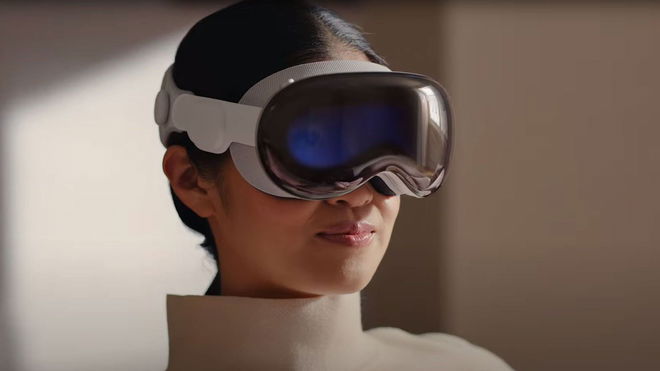 Woman sitting down while wearing the Apple Vision Pro headset