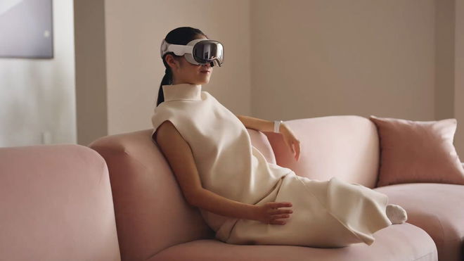 Woman using an Apple Vision Pro while sitting down on the sofa