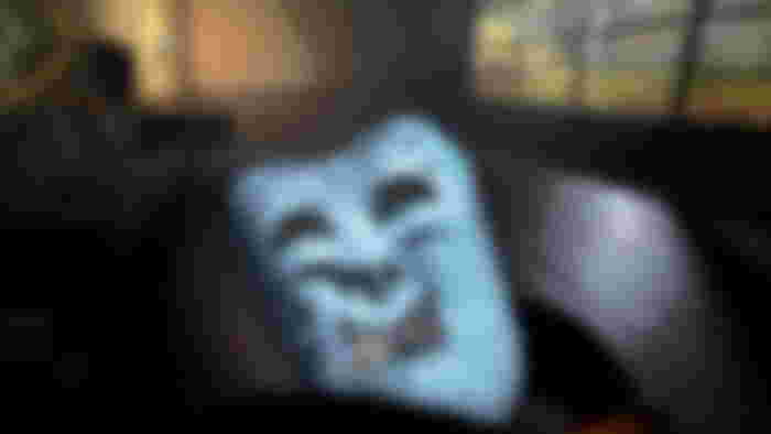 A player holding a Dramatic Mask