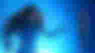 A human woman in a space tech suit from Homeworld 3 touching an Artifact