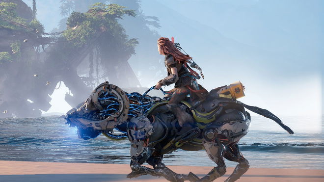 Aloy riding a machine on the coast in Horizon Forbidden West press image