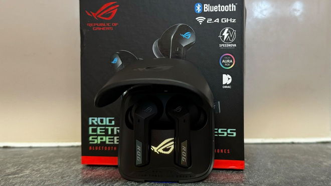 ASUS ROG Cetra earbuds inside the case in front of the box