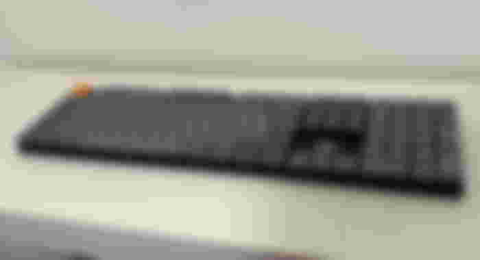 A black Keychron K5 Max keyboard with grey key caps and an orange ESC key in the top left.