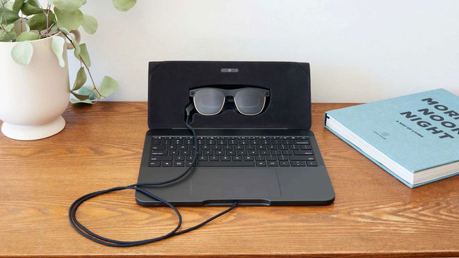 A pair of VR glasses is plugged into a Spacetop laptop