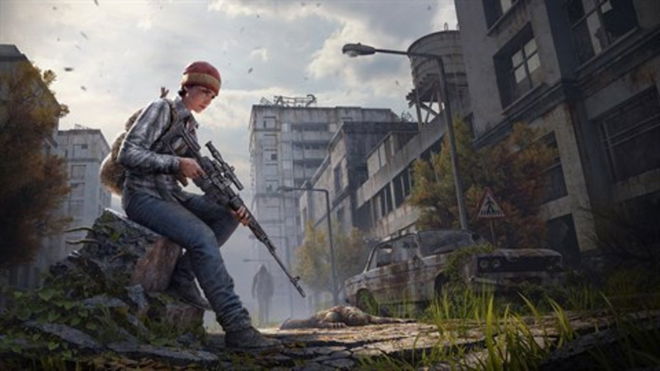 DayZ player holding gun with abandoned buildings in background
