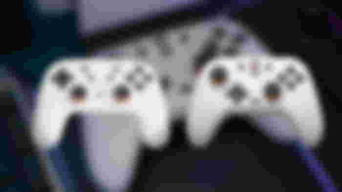 A Google Stadia controller next to a GameSir Nova Lite