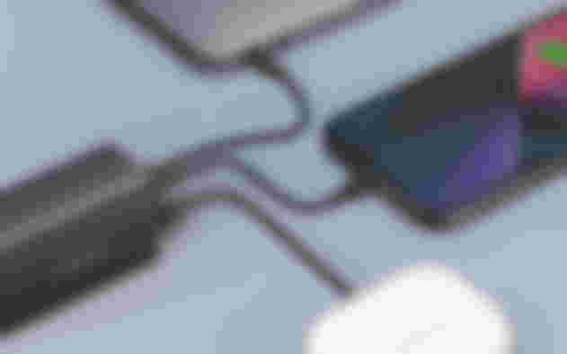 A gray USB C charging port connected to three different devices.