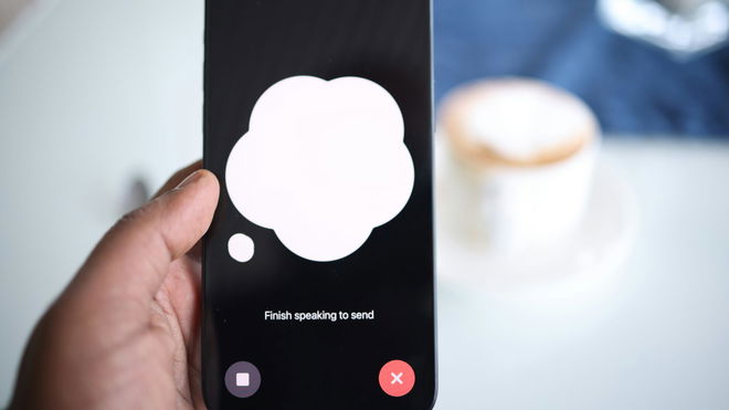 A person holding a cell phone with a speech bubble on the screen.