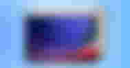 A light cream and black tablet with a purple, green, and red circular pattern on the display in front of a light blue paint-splattered background.