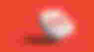 Gmail 3D icon in white in front of a red background.