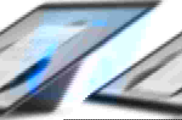 Microsoft Surface Go 2 product image of a tablet-style grey and black laptop with Windows up on the display.