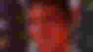 A red one-horned tiefling Karlach on a backdrop of the different dice in the expanded dice set mod for Baldur’s Gate 3