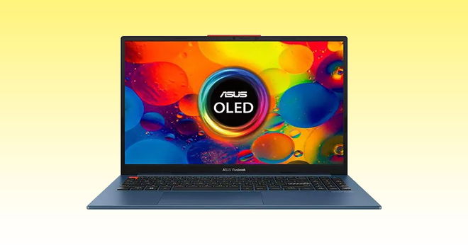 A blue laptop with black keys and a multicoloured pattern on the display in front of a yellow and white gradient background.