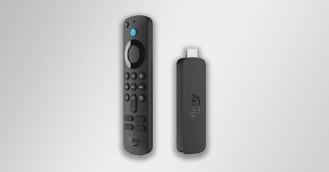 A black Amazon Fire TV Stick and USB in front of a gradient gray background.